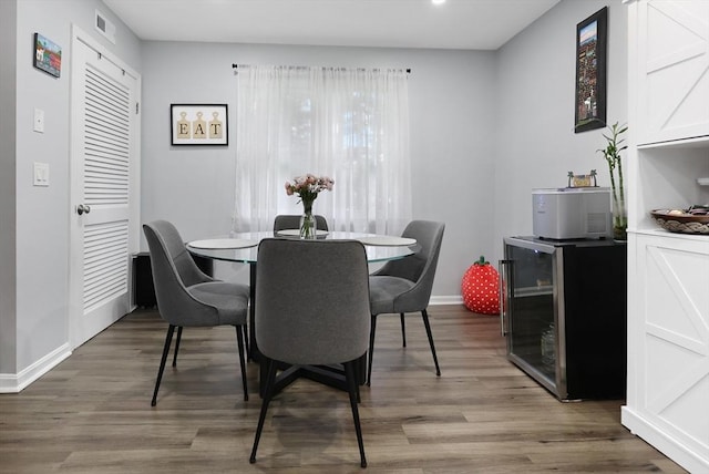 84 Tennis Plaza Rd Unit 46, Dracut, MA 01826 - dining room featuring beverage cooler, wood finished floors, and baseboards