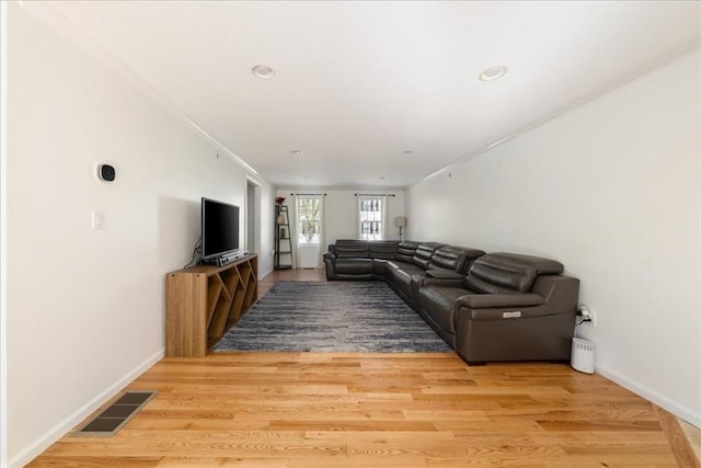 unfurnished living room featuring recessed lighting, baseboards, visible vents, and light wood finished floors