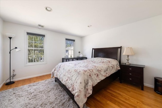 bedroom featuring recessed lighting, baseboards, visible vents, and light wood-style floors