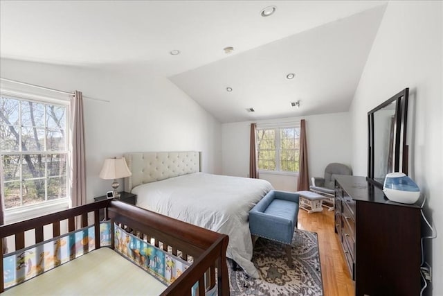 bedroom with light wood-style floors, vaulted ceiling, recessed lighting, and visible vents