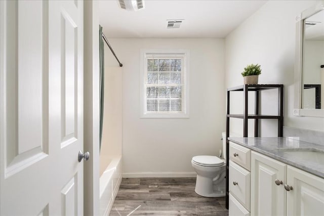 full bath with visible vents, wood finished floors, toilet, and vanity