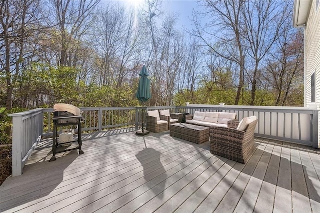 wooden terrace featuring an outdoor living space and a grill
