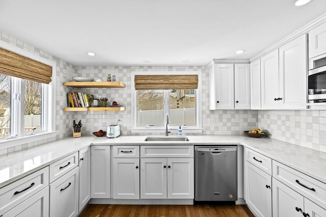 kitchen with recessed lighting, white cabinets, a sink, backsplash, and stainless steel appliances
