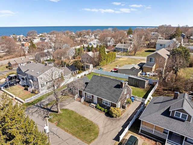 drone / aerial view featuring a residential view and a water view