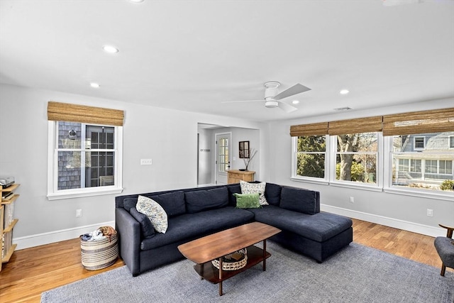 living area featuring a ceiling fan, visible vents, wood finished floors, baseboards, and recessed lighting