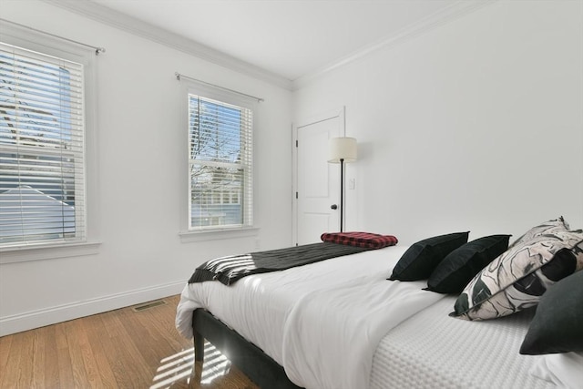 bedroom featuring hardwood / wood-style flooring and ornamental molding