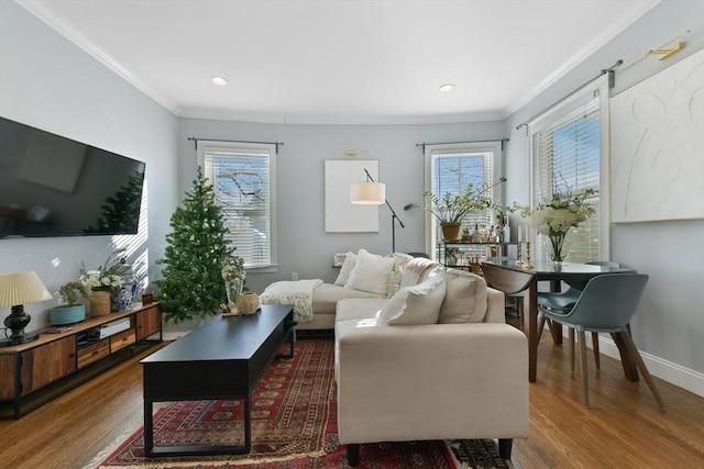 living room featuring ornamental molding, wood-type flooring, and plenty of natural light