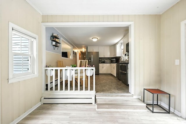 59 Searle Rd, South Hadley, MA 01075 - kitchen with stainless steel fridge with ice dispenser, light wood-style floors, ornamental molding, a baseboard radiator, and white cabinetry