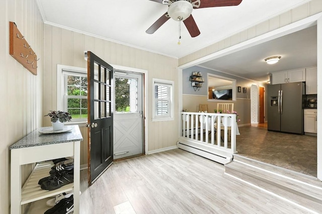 59 Searle Rd, South Hadley, MA 01075 - foyer entrance with ornamental molding, a baseboard radiator, light wood-style floors, and a ceiling fan