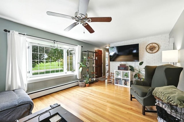 59 Searle Rd, South Hadley, MA 01075 - living room featuring baseboard heating, light wood-style flooring, ceiling fan, and brick wall