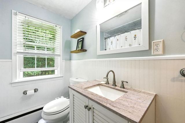 59 Searle Rd, South Hadley, MA 01075 - full bathroom featuring a baseboard heating unit, a wainscoted wall, vanity, and healthy amount of natural light