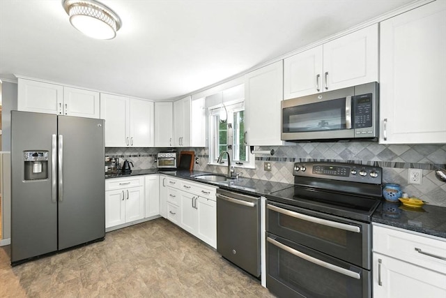 59 Searle Rd, South Hadley, MA 01075 - kitchen with stainless steel appliances, white cabinets, and decorative backsplash