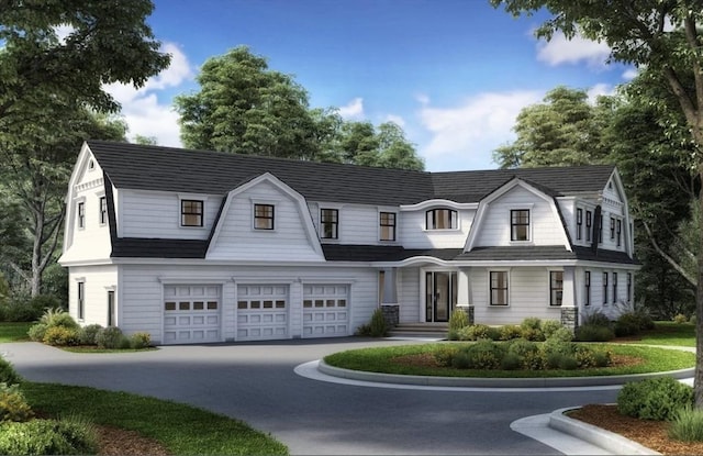 shingle-style home with a garage, driveway, and a gambrel roof