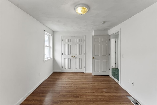 76 Choctaw Dr, Wareham, MA 02532 - unfurnished bedroom featuring dark wood-style flooring, baseboards, and a closet