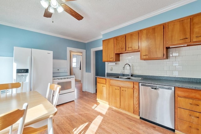 kitchen with crown molding, white appliances, sink, and a textured ceiling