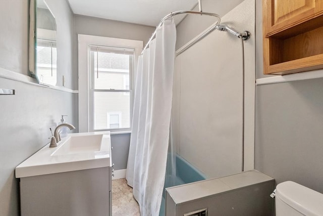 full bathroom featuring vanity, shower / bath combo, and toilet