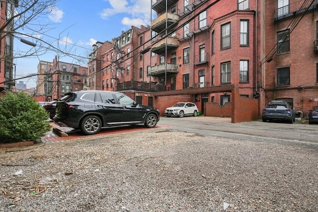 view of building exterior with uncovered parking