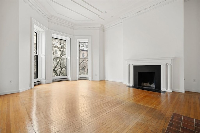 unfurnished living room with crown molding, a fireplace with flush hearth, baseboard heating, wood-type flooring, and baseboards