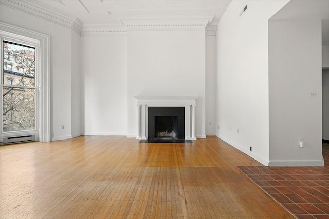 unfurnished living room featuring a fireplace with flush hearth, baseboard heating, baseboards, and wood finished floors