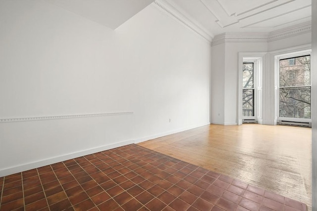 spare room with ornamental molding, baseboards, and a baseboard heating unit