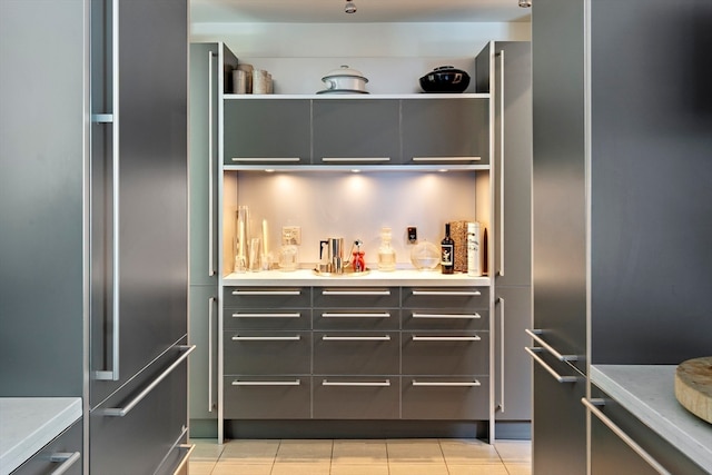 kitchen with light tile patterned floors and high quality fridge