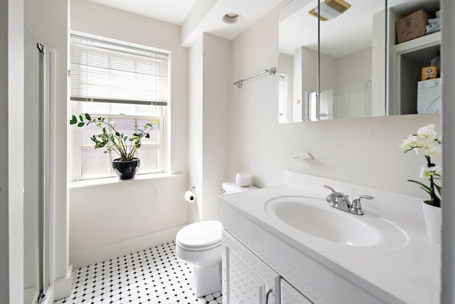 bathroom with vanity, toilet, plenty of natural light, and a shower