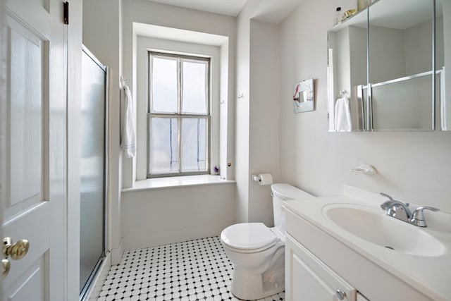 bathroom with vanity, toilet, and walk in shower