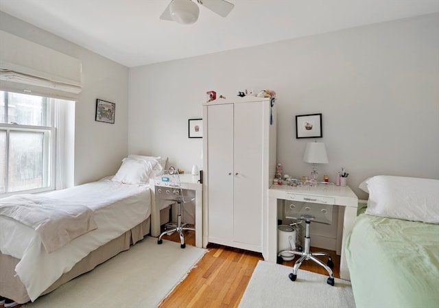 bedroom with light hardwood / wood-style flooring and ceiling fan