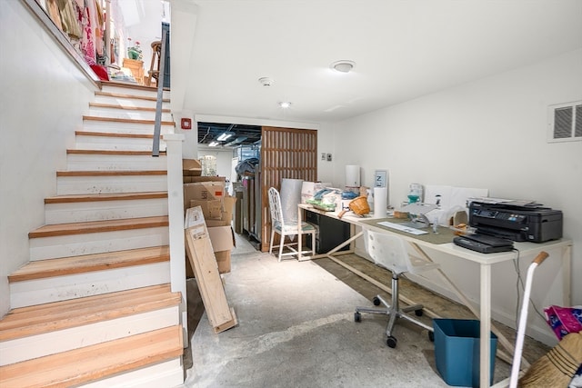 office space with concrete flooring