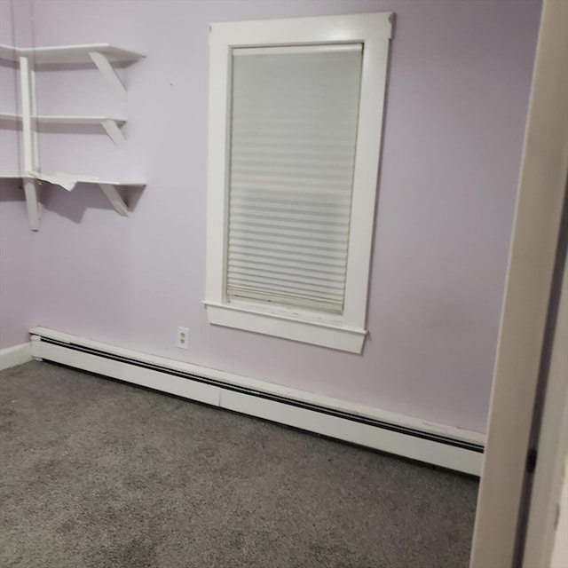 unfurnished room featuring a baseboard radiator and carpet