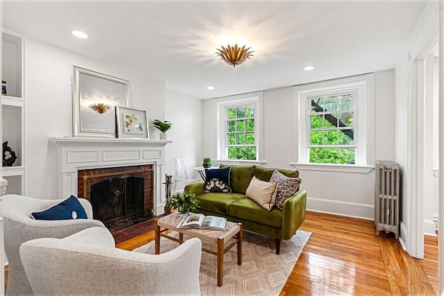 12 Lindall Pl Unit 3, Boston, MA 02114 - living room featuring radiator, light wood-style floors, a fireplace, baseboards, and recessed lighting