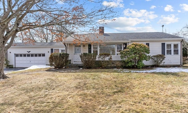 ranch-style house featuring an attached garage, a chimney, and a front yard