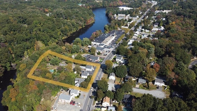 aerial view featuring a water view and a wooded view