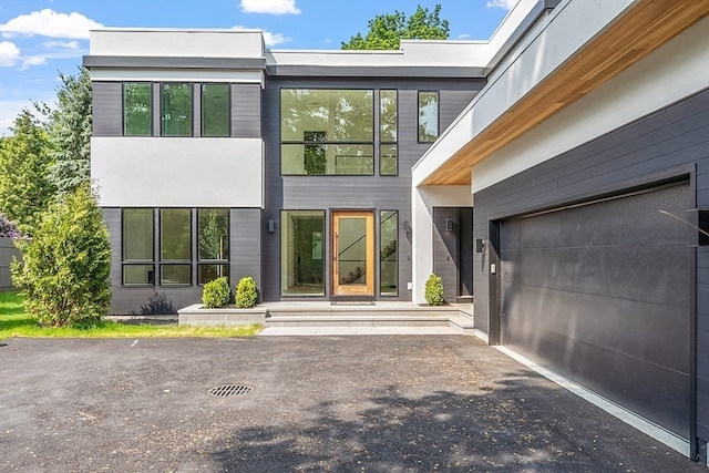 rear view of house featuring a garage