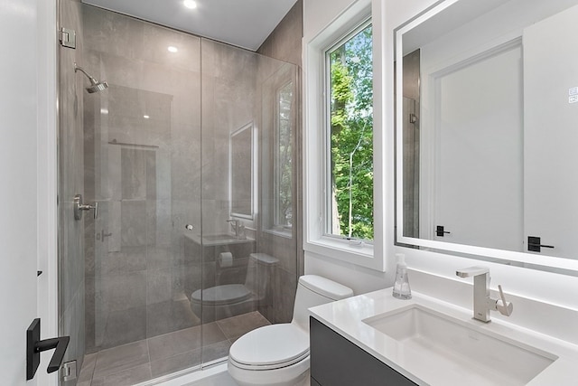 bathroom featuring a shower with door, toilet, and oversized vanity