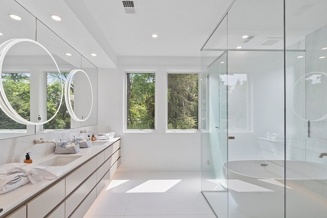 bathroom featuring a shower with door, dual bowl vanity, and tile flooring