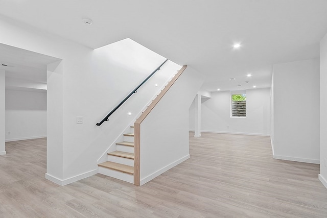 staircase with light wood-type flooring