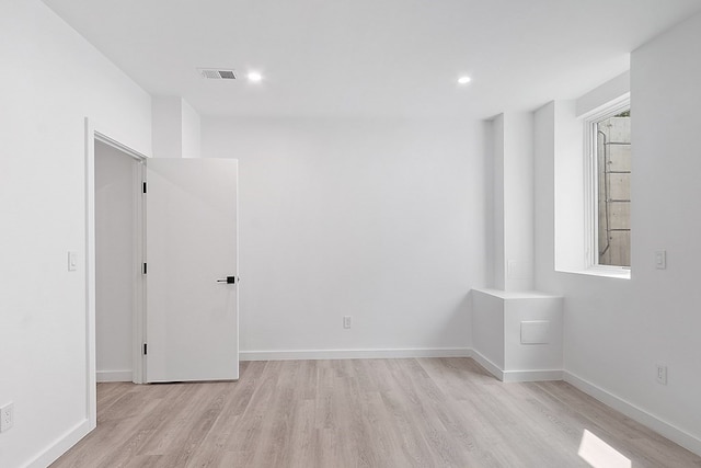 spare room with light hardwood / wood-style floors