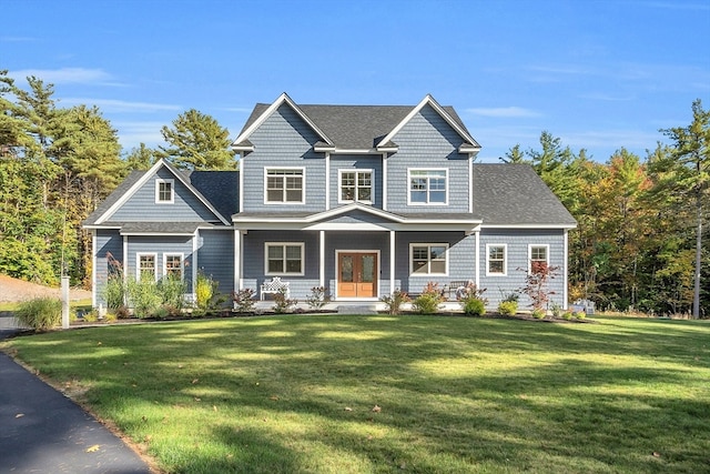 craftsman inspired home with a front lawn and covered porch