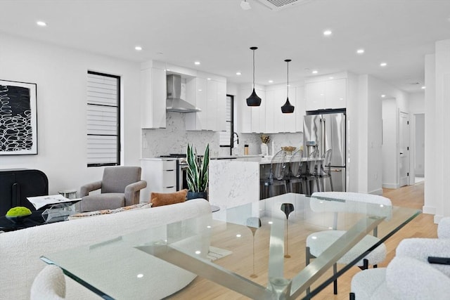 dining space featuring recessed lighting, visible vents, and light wood-style floors