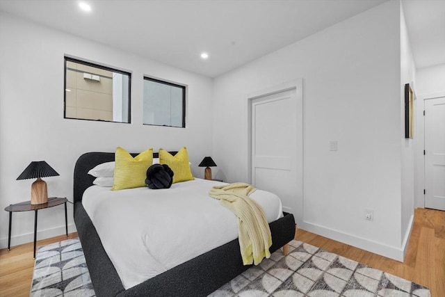 bedroom featuring light wood-style floors, baseboards, and recessed lighting