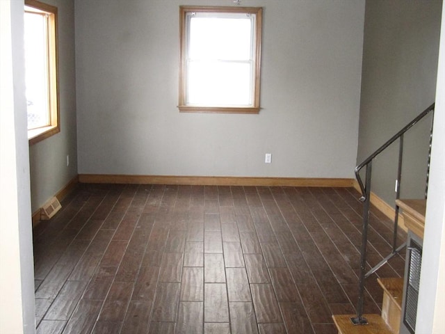 empty room with dark hardwood / wood-style flooring