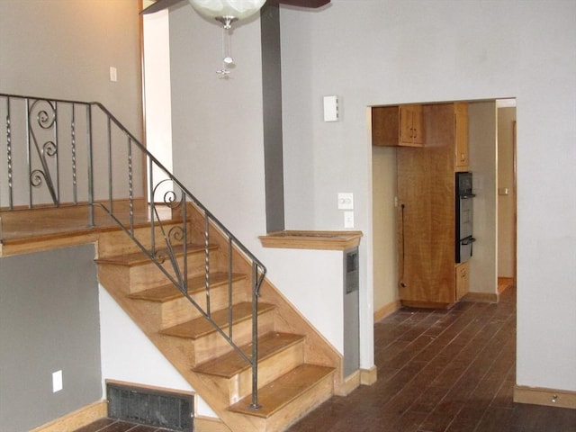 stairs featuring ceiling fan and wood-type flooring