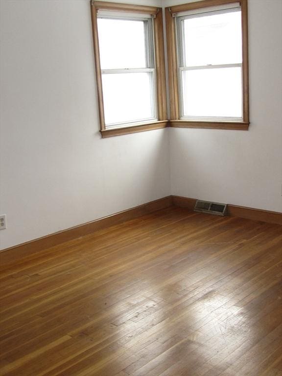 empty room with dark wood-type flooring