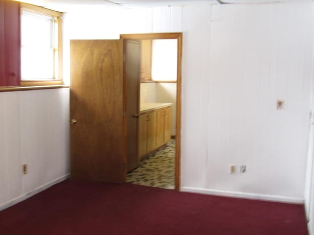 empty room featuring wooden walls