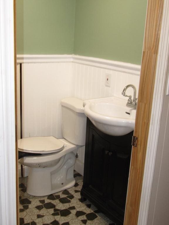 bathroom featuring toilet, vanity, and tile patterned flooring