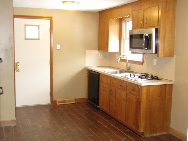 kitchen with sink, dishwasher, and white gas cooktop