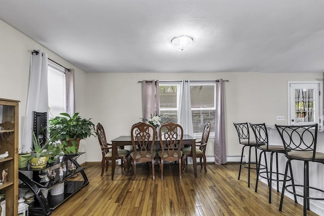 dining room featuring hardwood / wood-style floors and baseboards