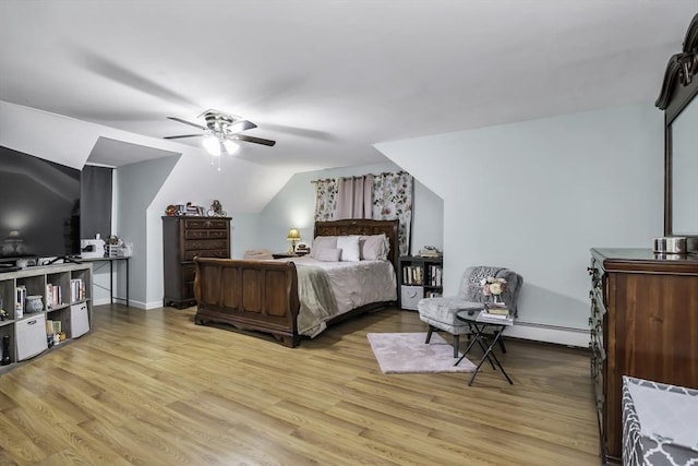 bedroom featuring vaulted ceiling, wood finished floors, ceiling fan, and baseboard heating