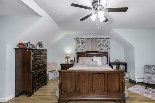 bedroom with baseboard heating, light wood finished floors, baseboards, lofted ceiling, and a ceiling fan